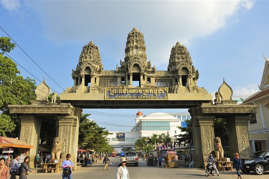 The grand stone entrance gate of the Kingdom of Cambodia at the Poipet border crossing in Banteay Meanchey
