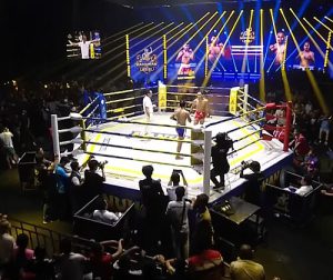 A live Kun Khmer martial arts match in Phnom Penh; get reliable transportation to the stadium with Phnom Penh Taxi Drive.