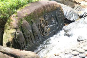 Ancient stone carvings of Hindu deities on the riverbed at Kbal Spean in Siem Reap Cambodia