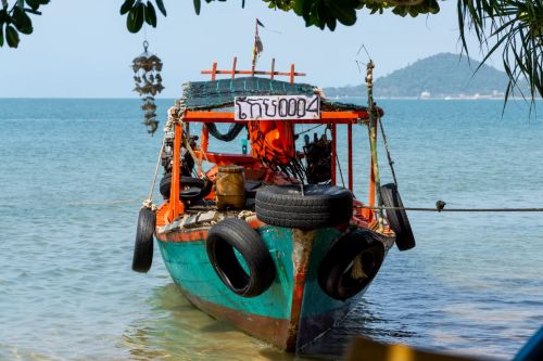 Traditional wooden tourist boat anchored at Koh Tonsay Rabbit Island in Kep Cambodia