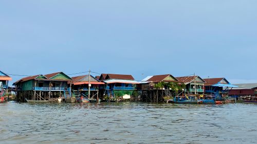 Traditional floating village houses on the Tonle Sap river in Kampong Chhnang, Cambodia, visited with Phnom Penh Taxi Driver.