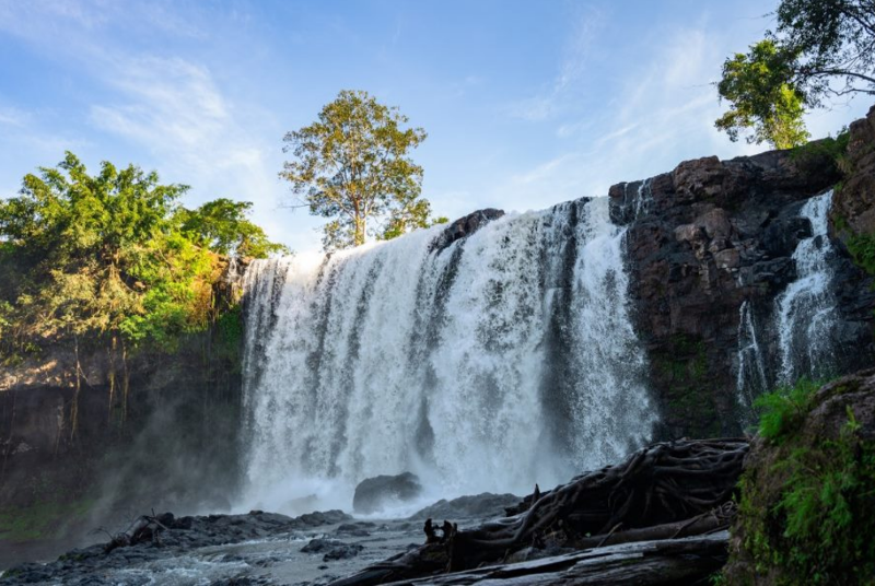 Wide view of the powerful Bousra Waterfall cascading over rocks in Mondulkiri Province Cambodia