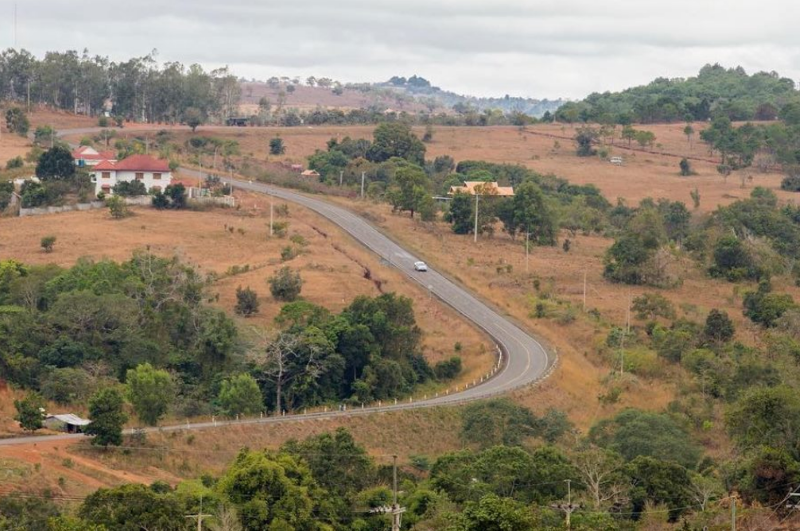 Aerial view of a winding mountain road and rolling green hills in Mondulkiri Province Cambodia