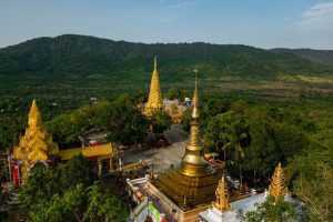 Golden pagodas of Wat Phnom Yat on a hilltop in Pailin, Cambodia, visited during a private tour by Phnom Penh Taxi Driver.