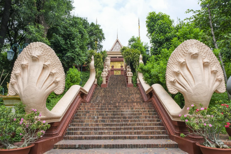 The grand Naga staircase leading up to Wat Phnom temple pagoda in Phnom Penh Cambodia
