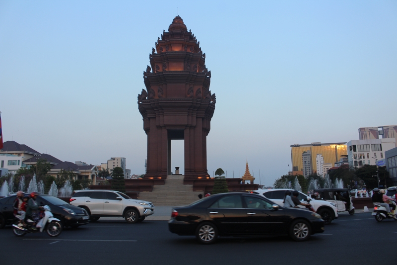 The Independence Monument in Phnom Penh Cambodia at dusk with city traffic
