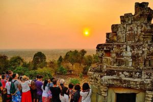 Tourists watching the golden sunset at Pre Rup temple mountain in Siem Reap Cambodia