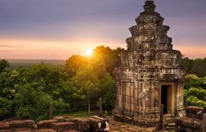 Sunset view of the ancient Phnom Bakheng temple on a hill overlooking Angkor Wat in Siem Reap.