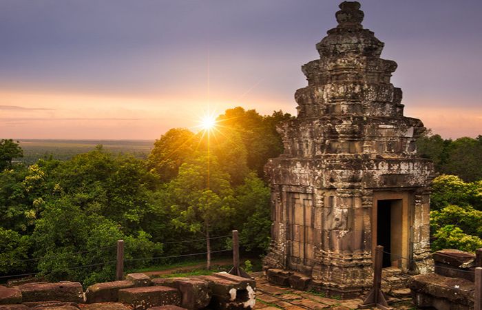Sunset view of the ancient Phnom Bakheng temple on a hill overlooking Angkor Wat in Siem Reap.