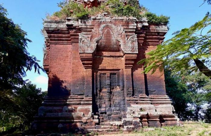 Ancient brick tower with stone carvings at Preah Ko temple, Roluos Group, Siem Reap.