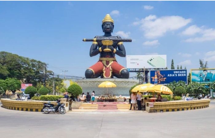 The giant black Ta Dumbong statue at the main roundabout in Battambang Cambodia
