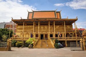 The ornate golden facade of Wat Kean Kleang Golden Temple in Phnom Penh Cambodia