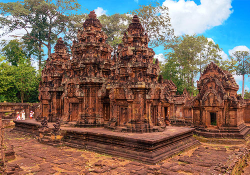The intricate red sandstone carvings and towers of Banteay Srei temple in Siem Reap Cambodia