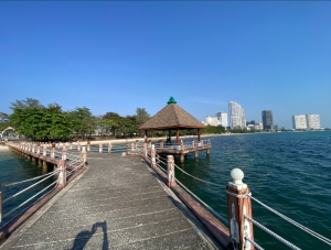 Scenic view of the Kampot pier and seaside pavilions with the city skyline in the background