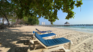 Relaxing beach chairs on white sand at a coastal resort near Kampot Cambodia