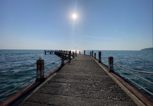 Scenic view of the wooden bridge pier in Kampot Cambodia during a sunset tour.