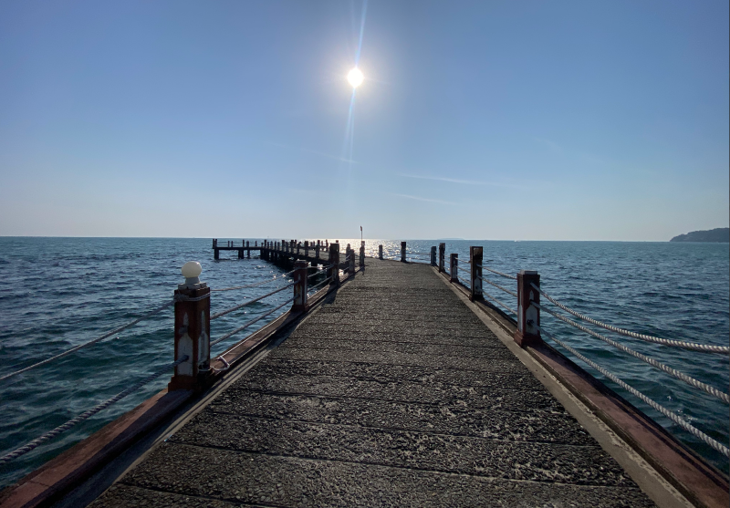 Scenic view of the wooden bridge pier in Kampot Cambodia during a sunset tour.
