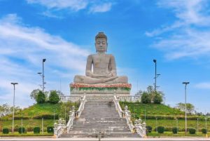 Large stone Buddha statue atop an ornate staircase at Vipassana Dhurak Buddhist Centre Oudong Cambodia