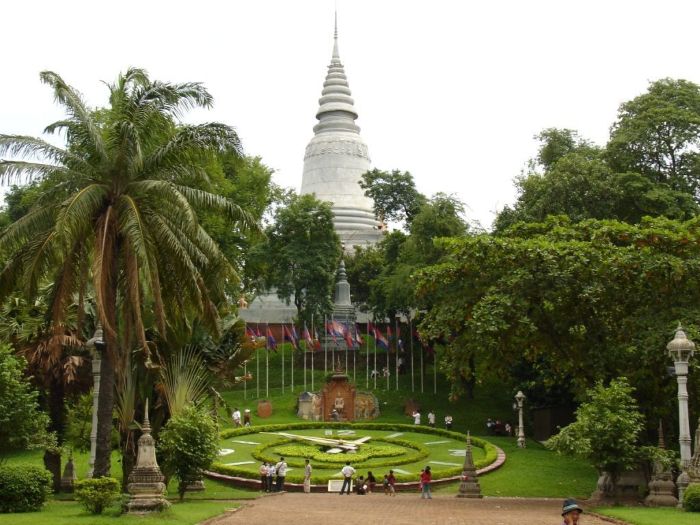 Scenic view of Wat Phnom Pagoda temple surrounded by lush gardens in Phnom Penh Cambodia