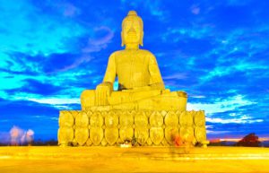 Golden seated Buddha statue at sunset on Phnom Svay mountain in Banteay Meanchey Cambodia
